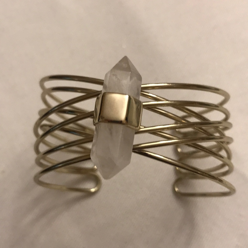 Gold bracelet with stone on top